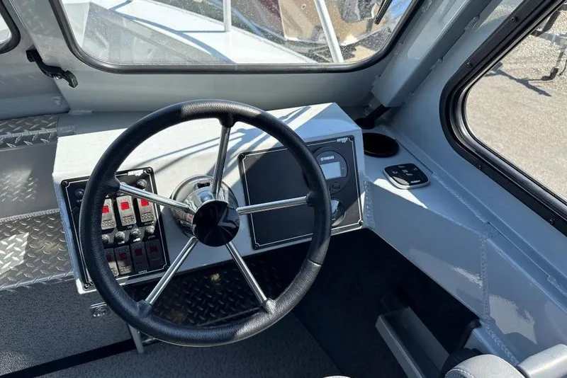 Slide: The Image of 2025 Hewescraft 210 Sea Runner ET HT boat dashboard with steering wheel and controls. - 6