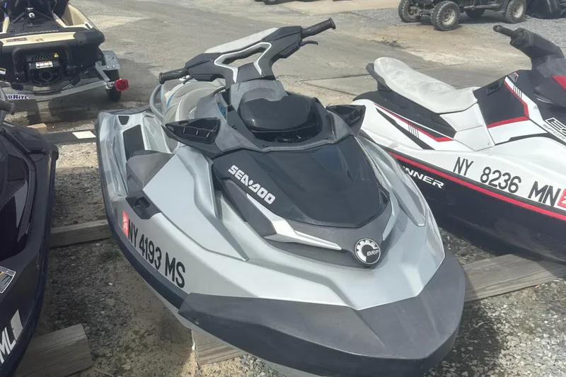 Slide: The Image of 2021 Sea-Doo GTX Limited 300 jet ski parked on gravel lot. - 3
