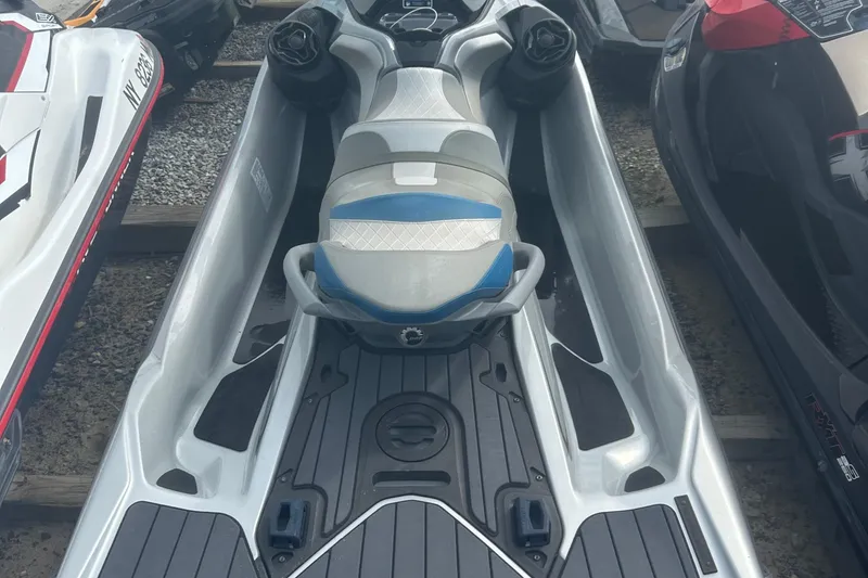 Slide: The Image of 2021 Sea-Doo GTX Limited 300 jet ski, silver and blue, parked on gravel. - 6