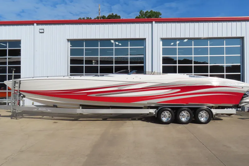The Image of 2013 Nordic 39 Poker Run boat with red and white design on a trailer. - 1