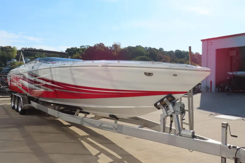 Slide: The Image of 2013 Nordic 39 Poker Run boat with red and white design on a trailer. - 10