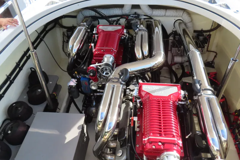 Slide: The Image of Engine compartment of a 2013 Nordic 39 POKER RUN boat with dual red engines. - 13