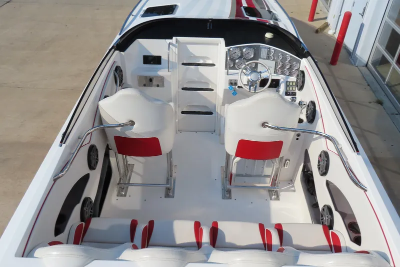 Slide: The Image of 2013 Nordic 39 Poker Run boat interior with white and red seating, modern dashboard, and steering wheel. - 15