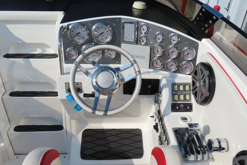Slide: The Image of Cockpit of 2013 Nordic 39 POKER RUN boat with gauges, steering wheel, and controls. - 16