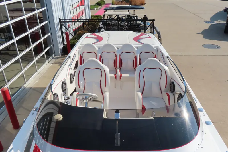 Slide: The Image of 2013 Nordic 39 POKER RUN boat with sleek white and red seating, docked outdoors. - 25