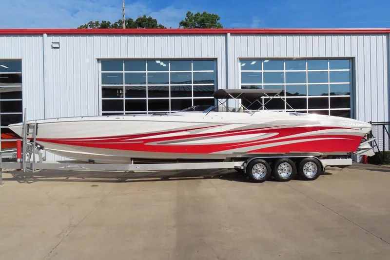 Slide: The Image of 2013 Nordic 39 POKER RUN boat with red and white design on a trailer. - 4