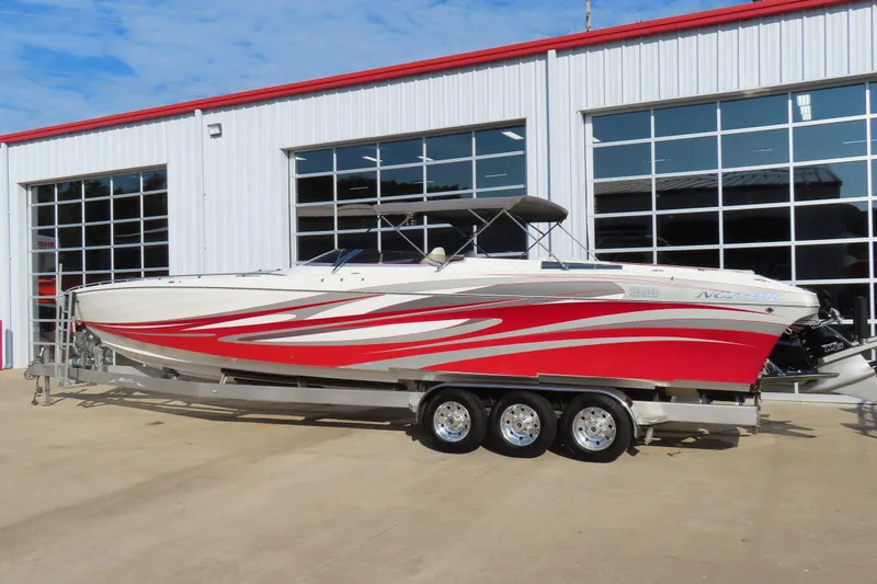 Slide: The Image of 2013 Nordic 39 POKER RUN boat with red and white design on a trailer. - 5