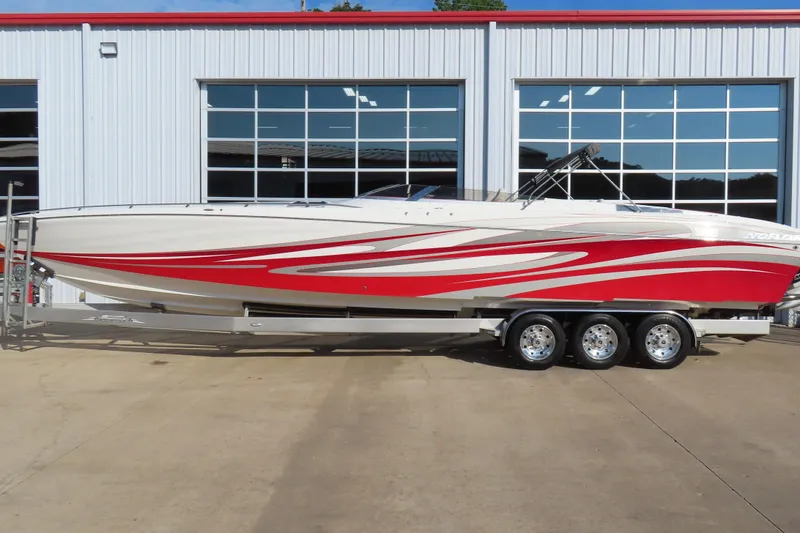 Slide: The Image of 2013 Nordic 39 Poker Run boat with red and white design on a trailer. - 8