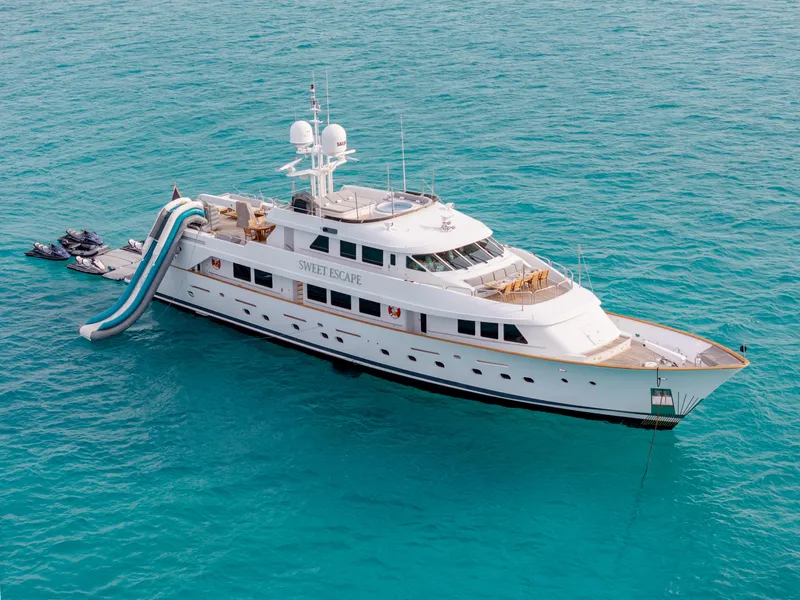 Slide: The Image of Luxury 1993 Christensen Semi Displacement yacht with water slide in turquoise sea. - 0
