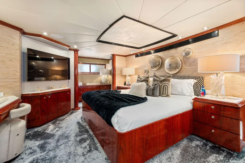 Slide: The Image of Luxurious bedroom interior of 1993 Christensen Semi Displacement yacht with modern decor and wooden furnishings. - 11