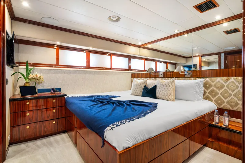 Slide: The Image of Luxurious bedroom on a 1993 Christensen Semi Displacement yacht with elegant wood finishes. - 14