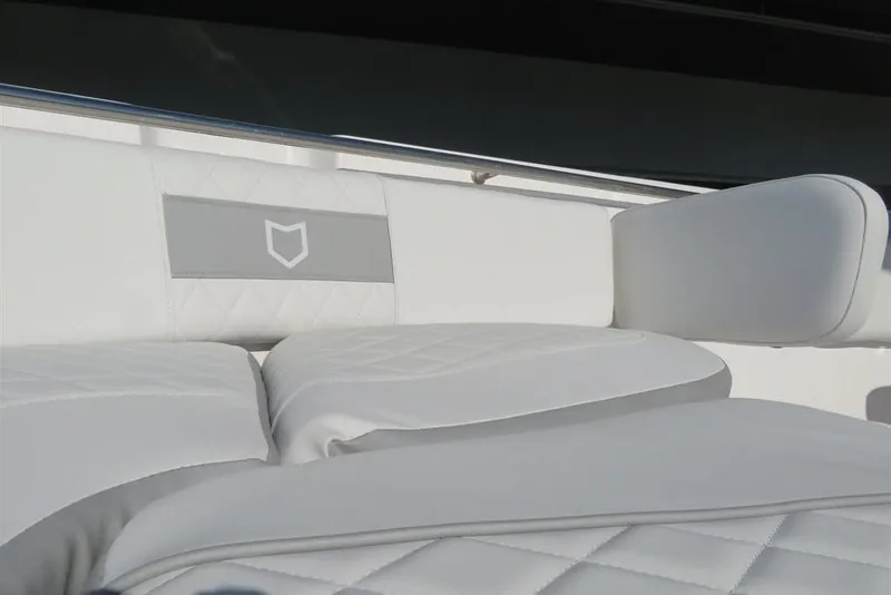 Slide: The Image of 2024 Sea Fox 288 Commander boat seating with quilted white upholstery and logo detail. - 18