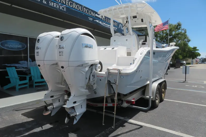 Slide: The Image of 2024 Sea Fox 288 Commander boat with twin Yamaha engines on a trailer. - 2