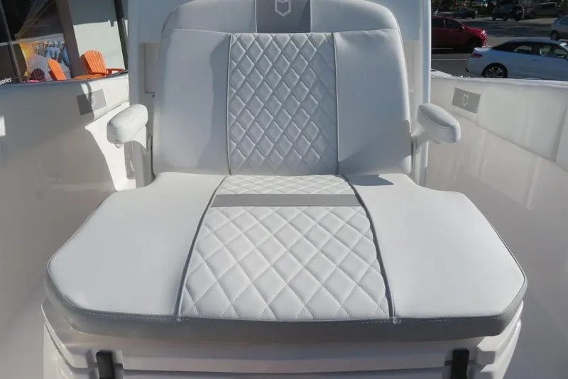 Slide: The Image of 2024 Sea Fox 288 Commander boat seat with white quilted upholstery and armrests. - 28