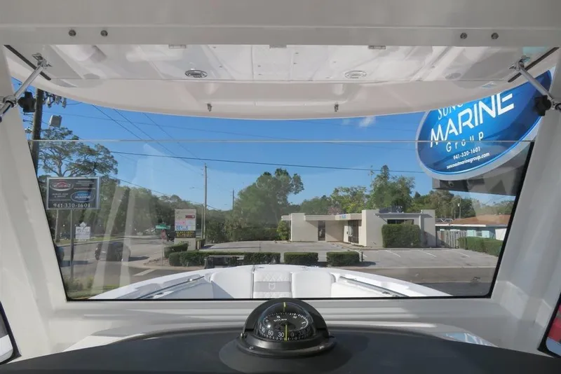 Slide: The Image of View from 2024 Sea Fox 288 Commander boat cockpit, showcasing marina and compass. - 29