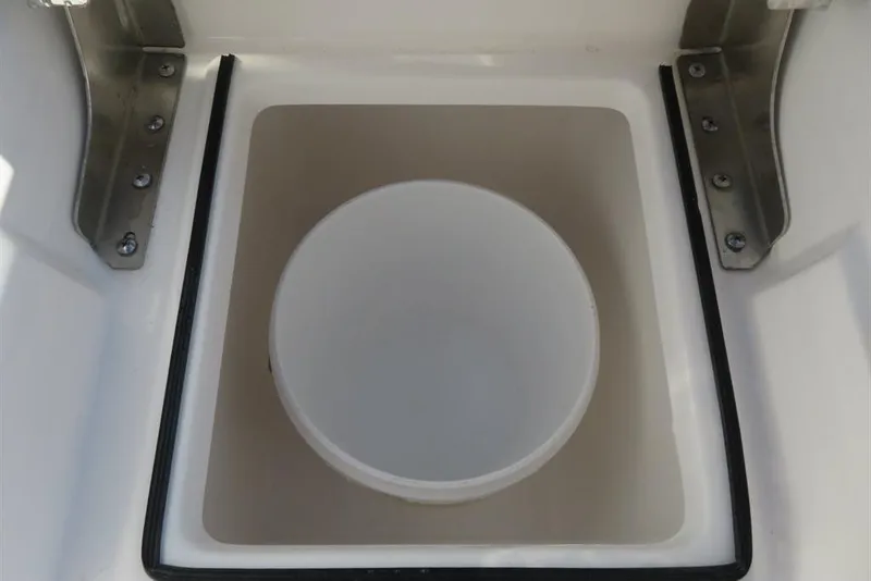 Slide: The Image of 2024 Sea Fox 288 Commander storage compartment with a white bucket inside. - 35