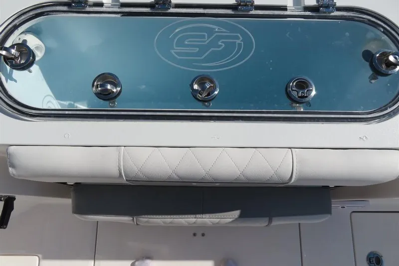 Slide: The Image of 2024 Sea Fox 288 Commander boat dashboard with control knobs and cushioned seating. - 41