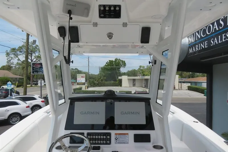 Slide: The Image of 2024 Sea Fox 288 Commander boat dashboard with Garmin displays at marine sales location. - 51
