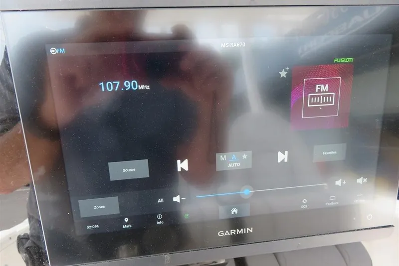 Slide: The Image of Garmin display on 2024 Sea Fox 288 Commander showing FM radio at 107.90 MHz. - 60