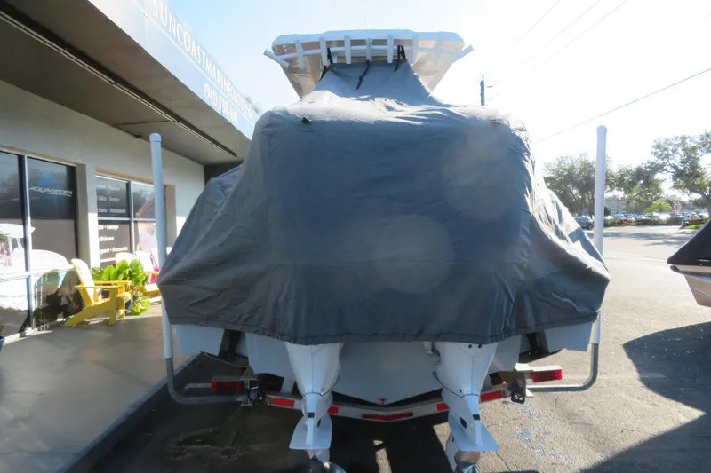 Slide: The Image of 2024 Sea Fox 288 Commander boat covered, parked outside a marine dealership. - 73