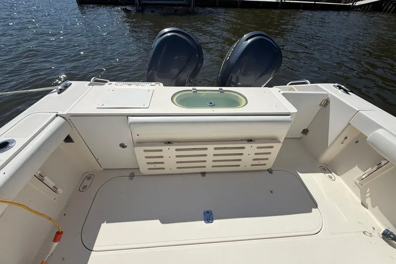 Slide: The Image of 2006 Pursuit 3370 Offshore boat deck with dual engines and storage compartments. - 10