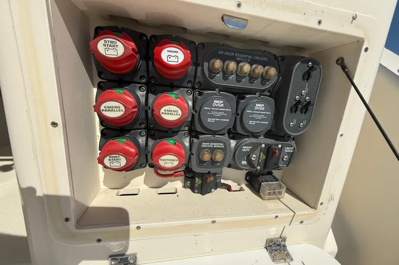 Slide: The Image of Electrical panel of a 2006 Pursuit 3370 Offshore boat, featuring circuit switches and modules. - 11