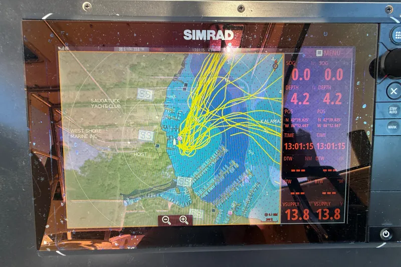 Slide: The Image of Simrad marine GPS display on 2006 Pursuit 3370 Offshore boat, showing navigation data and map. - 21