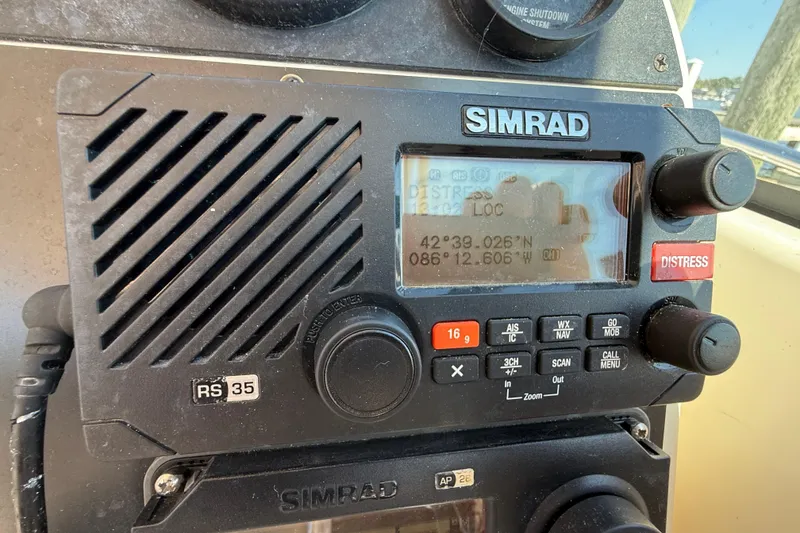 Slide: The Image of Simrad RS35 marine radio on 2006 Pursuit 3370 Offshore boat, displaying coordinates. - 23