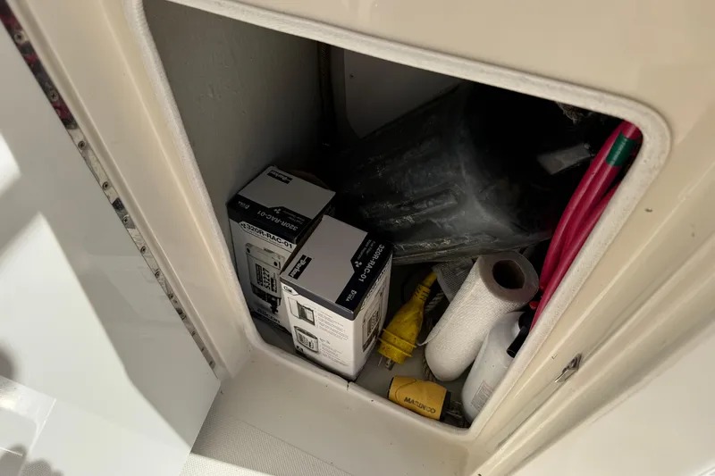 Slide: The Image of Storage compartment in a 2006 Pursuit 3370 Offshore boat with supplies and equipment. - 25