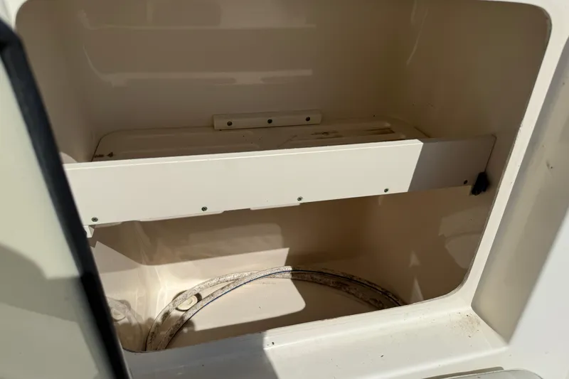 Slide: The Image of Empty storage compartment in a 2006 Pursuit 3370 Offshore boat. - 27
