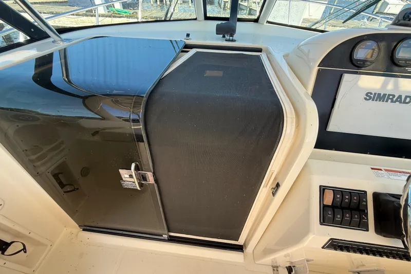 Slide: The Image of 2006 Pursuit 3370 Offshore boat cockpit with Simrad electronics and control panel. - 31