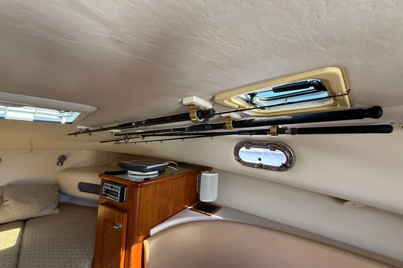 Slide: The Image of Interior of a 2006 Pursuit 3370 Offshore boat with fishing rods stored overhead. - 33