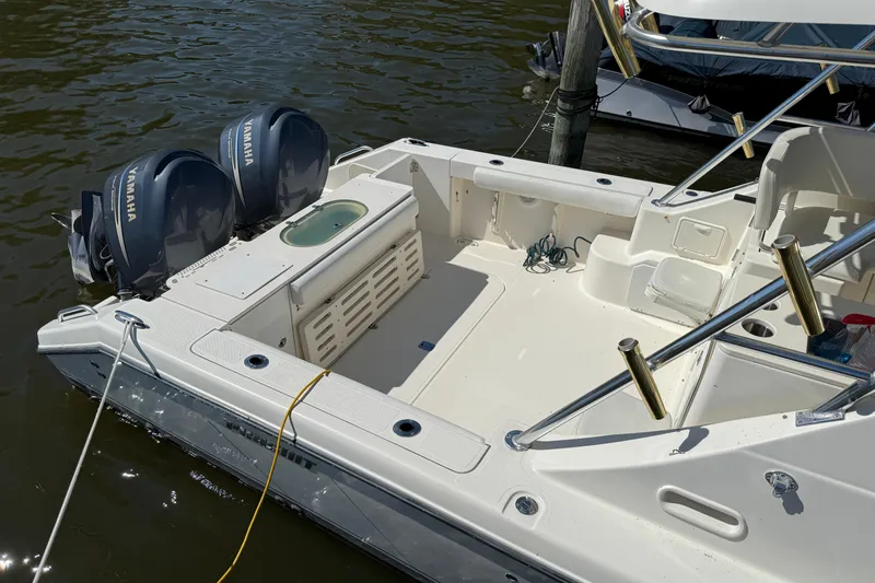 Slide: The Image of 2006 Pursuit 3370 Offshore boat with dual Yamaha engines docked on water. - 4