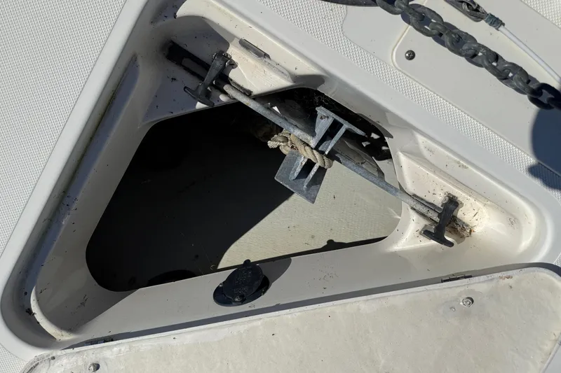Slide: The Image of Anchor compartment of 2006 Pursuit 3370 Offshore boat with chain and rope. - 6