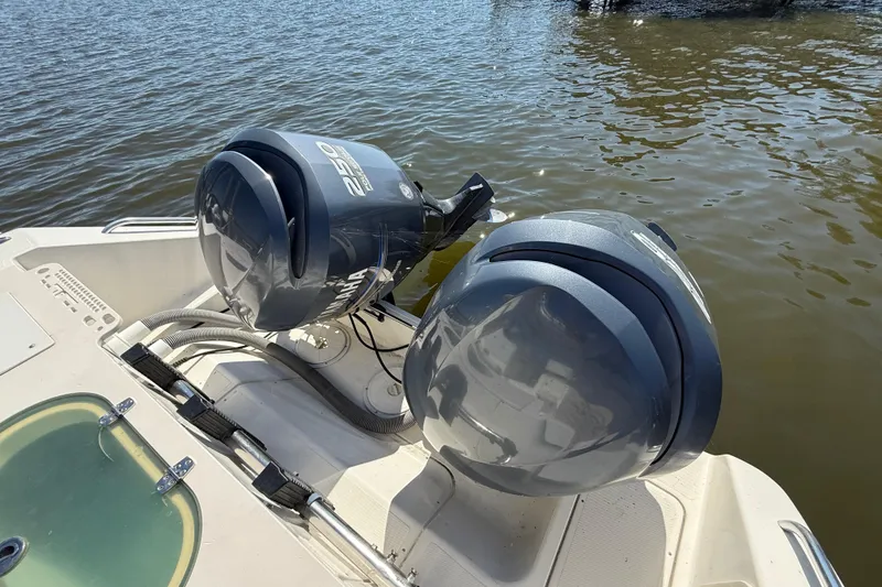 Slide: The Image of 2006 Pursuit 3370 Offshore boat with twin outboard motors on water. - 8