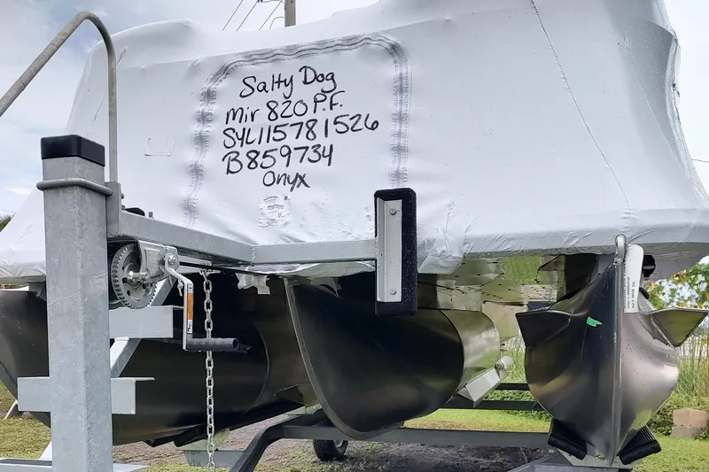 Slide: The Image of 2026 Sylvan Mirage 820 PARTY FISH boat on trailer, covered and labeled "Salty Dog." - 16