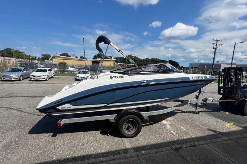 Slide: The Image of 2020 Yamaha SX190 boat on trailer under clear blue sky. - 10