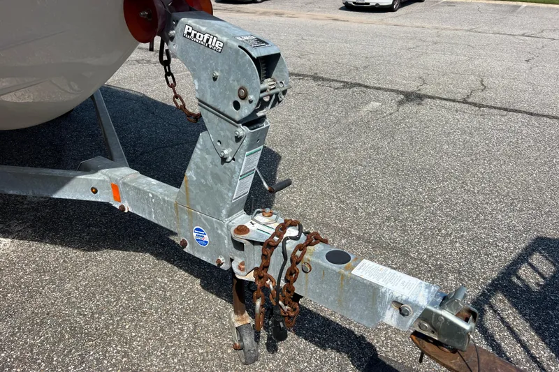 Slide: The Image of Trailer hitch of a 2020 Yamaha Boats SX190 with rusted chains on asphalt. - 14