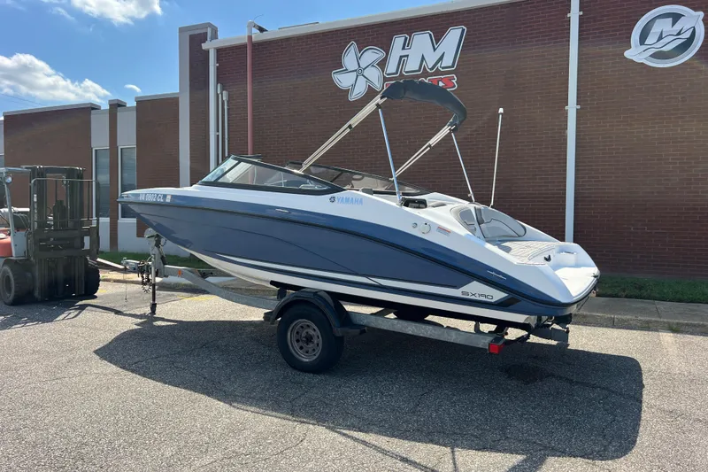 Slide: The Image of 2020 Yamaha SX190 boat on trailer outside HM Boats building. - 2