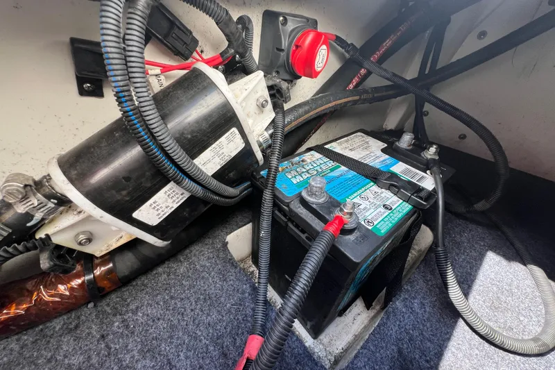 Slide: The Image of Battery and wiring inside a 2020 Yamaha Boats SX190, showcasing marine electrical components. - 26