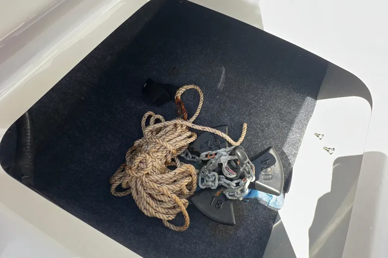 Slide: The Image of Storage compartment of 2020 Yamaha SX190 boat with anchor and rope. - 28