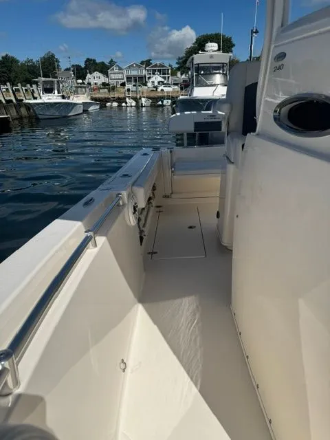 Slide: The Image of 2020 Cobia 240 Center Console boat docked at marina, clear sky, calm water. - 13