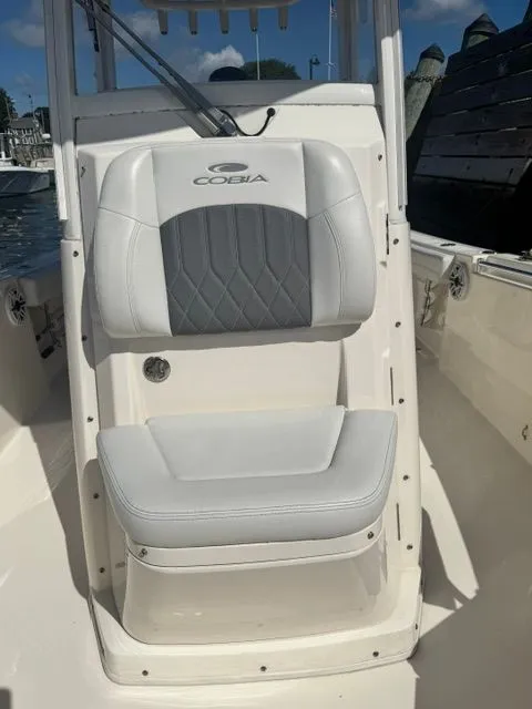 Slide: The Image of 2020 Cobia 240 Center Console boat seat with gray and white upholstery. - 14