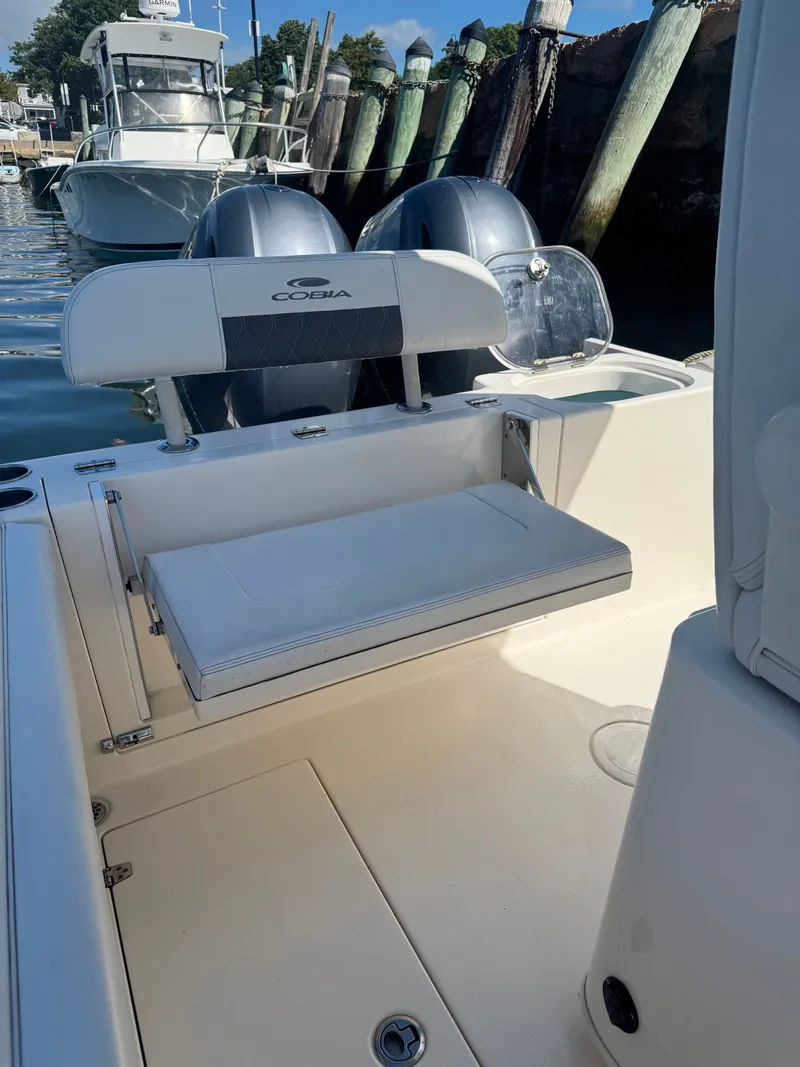 Slide: The Image of 2020 Cobia 240 Center Console boat with dual engines at dock. - 15