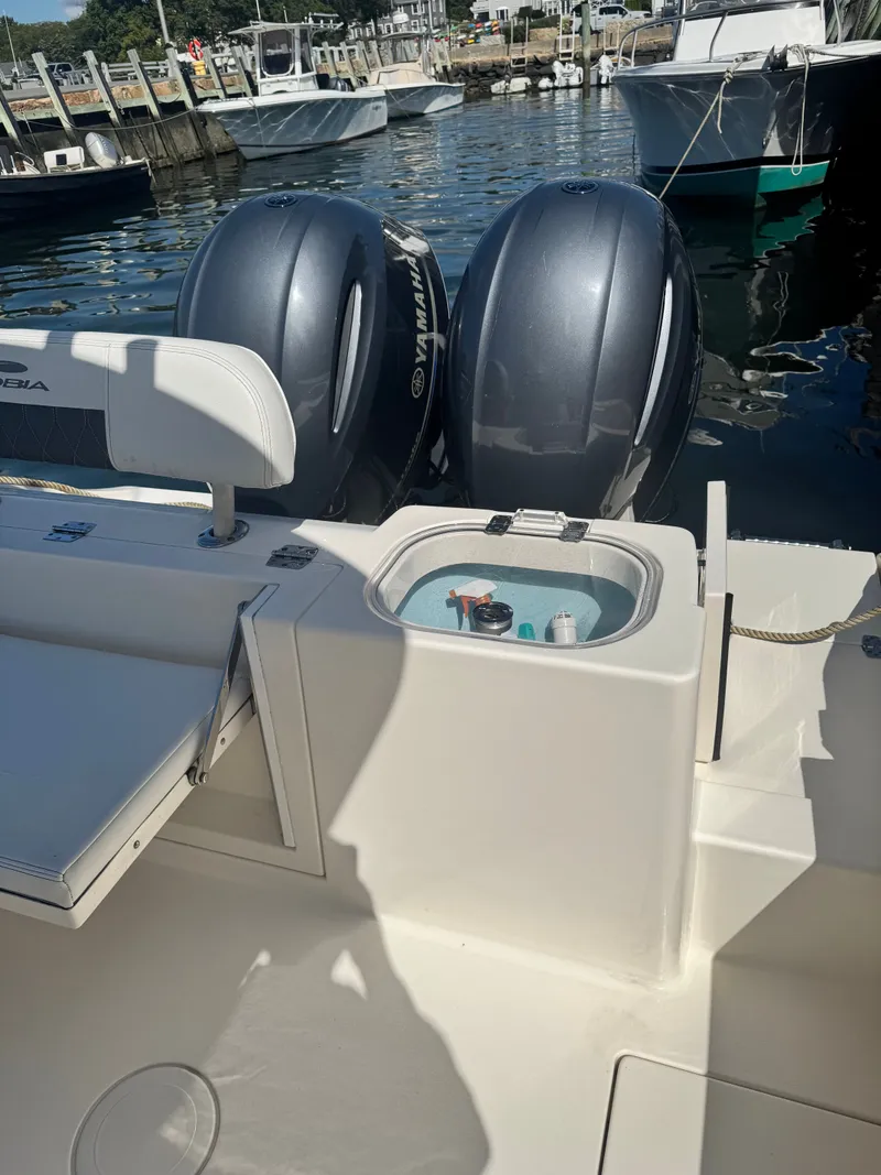 Slide: The Image of 2020 Cobia 240 Center Console boat with twin Yamaha engines at dock. - 16