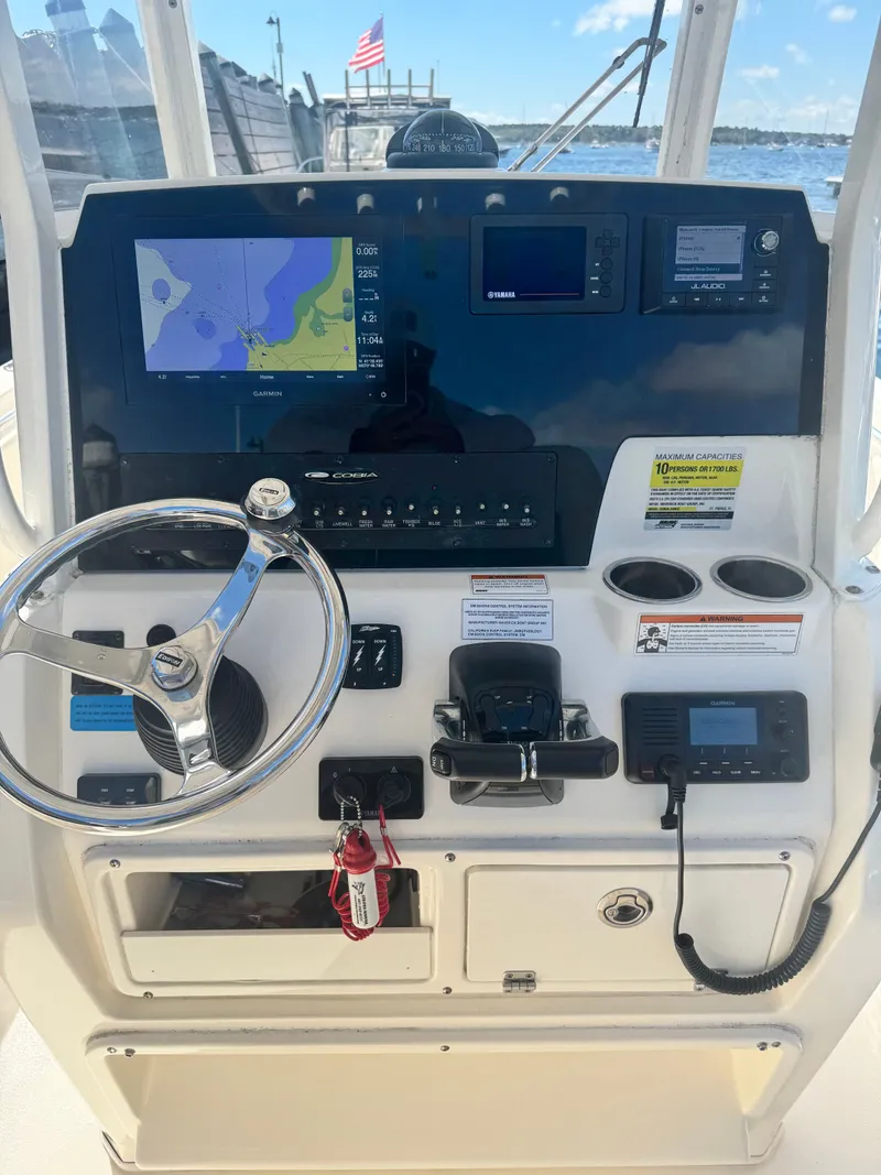 Slide: The Image of Cobia 240 Center Console 2020 dashboard with navigation and control systems. - 17