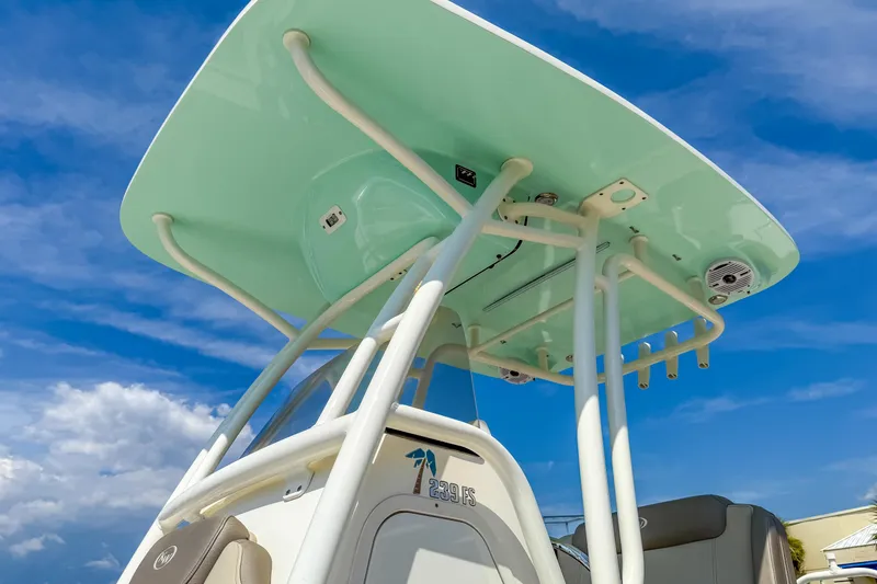 Slide: The Image of 2021 Key West 239 FS boat with T-top against a clear blue sky. - 11