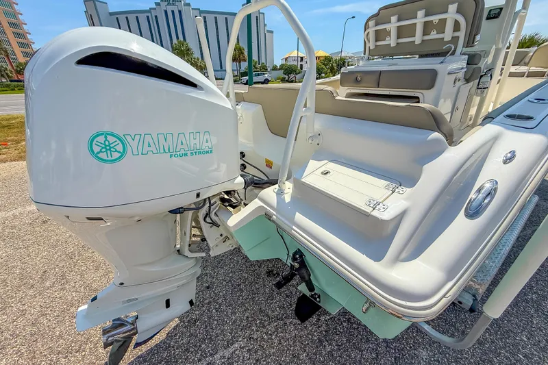 Slide: The Image of 2021 Key West 239 FS boat with Yamaha four-stroke engine, parked outdoors. - 12
