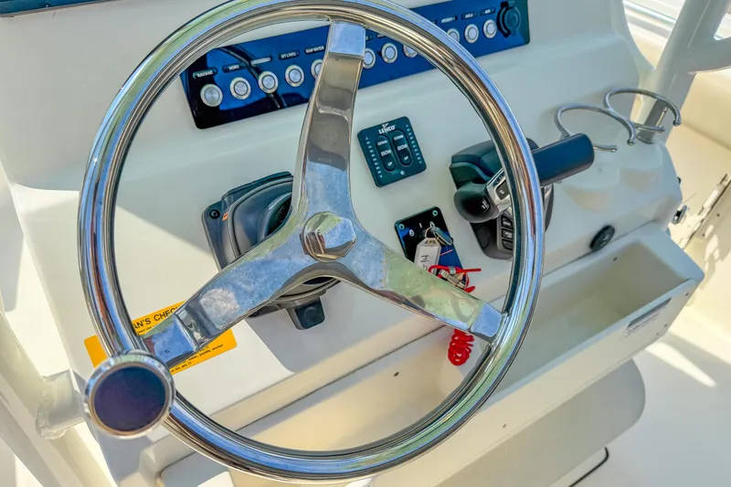Slide: The Image of Steering wheel and controls of 2021 Key West 239 FS boat cockpit. - 15