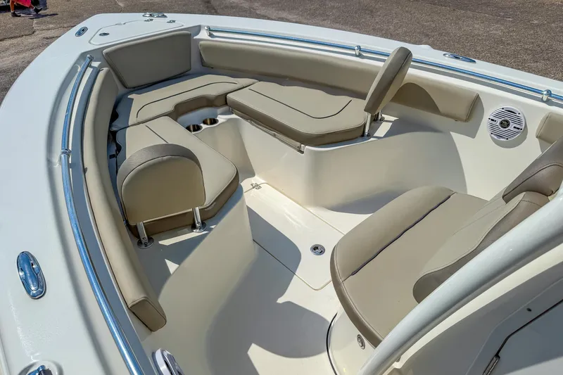 Slide: The Image of 2021 Key West 239 FS boat interior with beige seating and cup holders. - 17